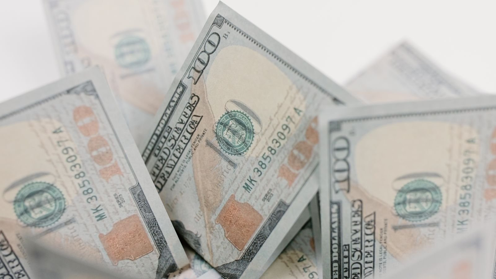 Close-up of US hundred dollar bills, representing Nvidia's capital return to shareholders through dividends and buybacks