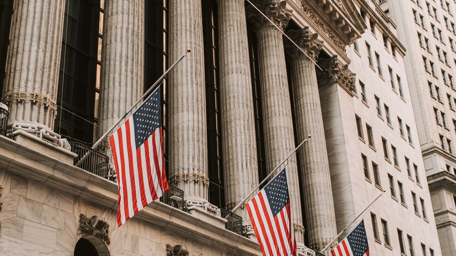 Iconic New York Stock Exchange with American flags on Wall Street, representing this week's stock market trading action