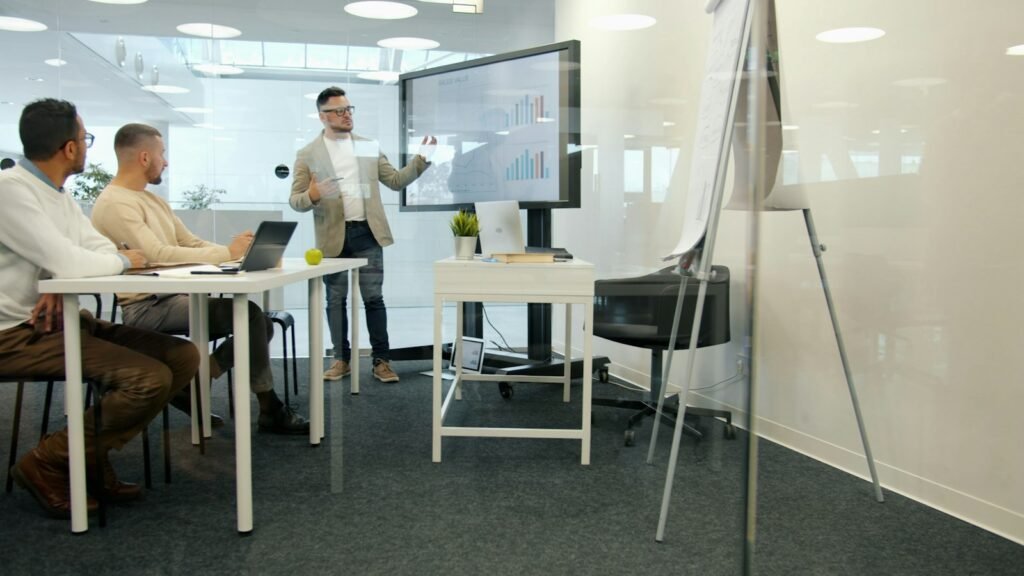 Executive presenting finance results to colleagues in a boardroom