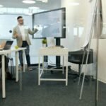 Executive presenting finance results to colleagues in a boardroom