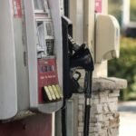 Gas pump beside a brick wall, illustrating gasoline's effect on headline inflation