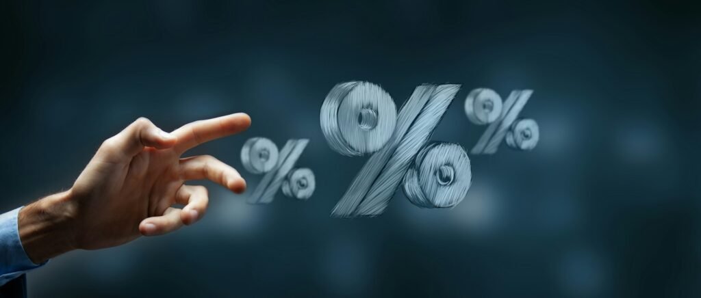Hand reaching toward floating percentage symbols representing interest rates