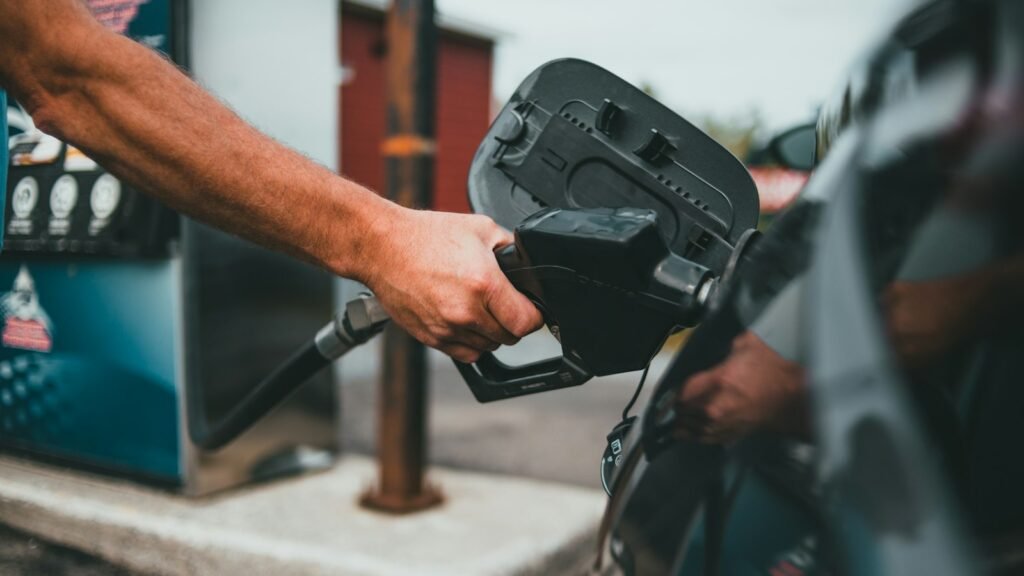 Person fueling a car at a gas station