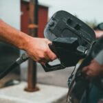Person fueling a car at a gas station