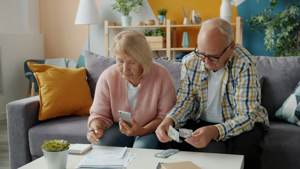 Elderly couple managing finances and bills together at home