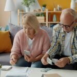 Elderly couple managing finances and bills together at home